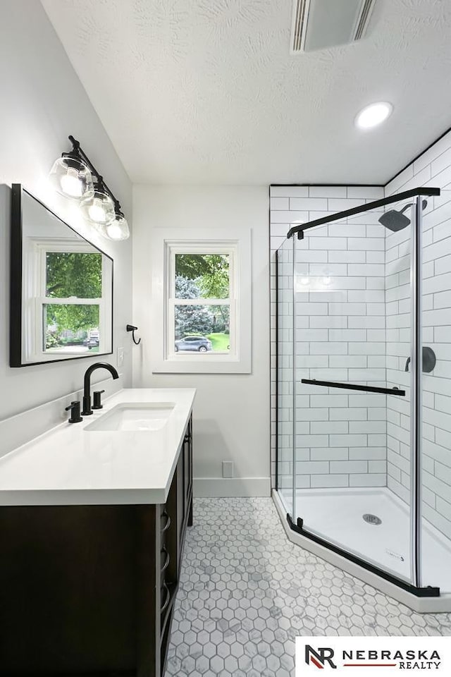 1113 S 94th St, Omaha, NE 68124 - bathroom with vanity, a textured ceiling, a shower stall, and recessed lighting