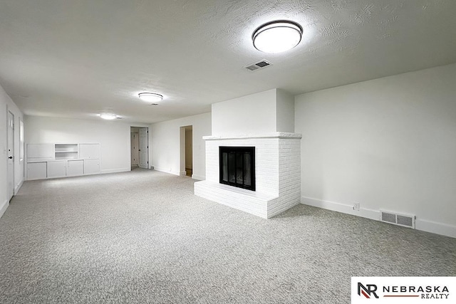 1113 S 94th St, Omaha, NE 68124 - unfurnished living room featuring carpet, a brick fireplace, and a textured ceiling