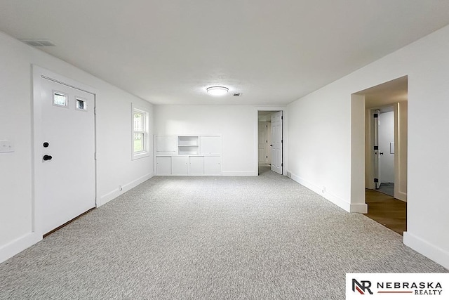 1113 S 94th St, Omaha, NE 68124 - unfurnished living room featuring baseboards and carpet flooring