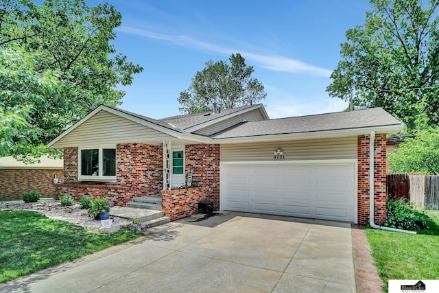 4721 Woodhaven Dr, Lincoln, NE 68516 - ranch-style house with brick siding, concrete driveway, an attached garage, and a shingled roof