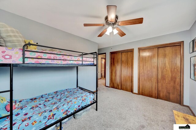 4721 Woodhaven Dr, Lincoln, NE 68516 - bedroom featuring multiple closets, carpet, and a ceiling fan
