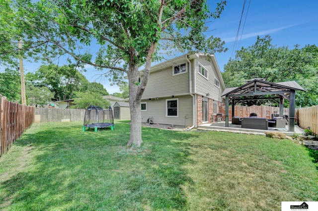 4721 Woodhaven Dr, Lincoln, NE 68516 - rear view of property with a trampoline, an outdoor living space, a gazebo, a fenced backyard, and a patio