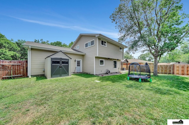4721 Woodhaven Dr, Lincoln, NE 68516 - rear view of house featuring a trampoline, a fenced backyard, and a storage unit
