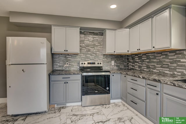 4317 S 37th St, Omaha, NE 68107 - kitchen featuring freestanding refrigerator, stainless steel range with electric cooktop, light marble finish floors, recessed lighting, and backsplash