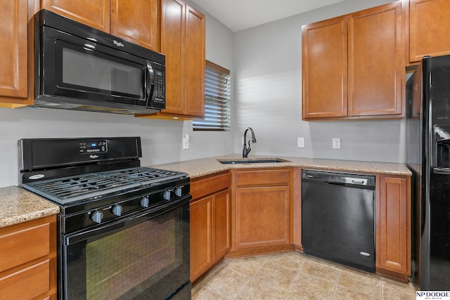 20709 Larimore Ave, Elkhorn, NE 68022 - kitchen featuring black appliances, brown cabinets, and light stone countertops