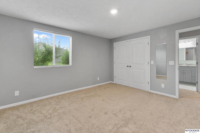 20709 Larimore Ave, Elkhorn, NE 68022 - unfurnished bedroom with carpet, ensuite bathroom, a closet, and recessed lighting