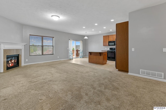 20709 Larimore Ave, Elkhorn, NE 68022 - unfurnished living room with recessed lighting, light colored carpet, and a tiled fireplace