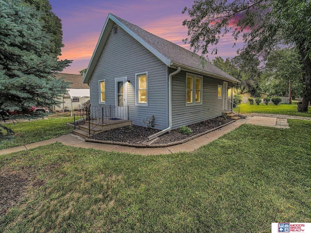 4308 N 70th St, Lincoln, NE 68507 - view of side of property featuring a lawn and roof with shingles