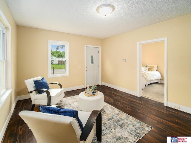 4308 N 70th St, Lincoln, NE 68507 - sitting room with dark wood-type flooring and a textured ceiling