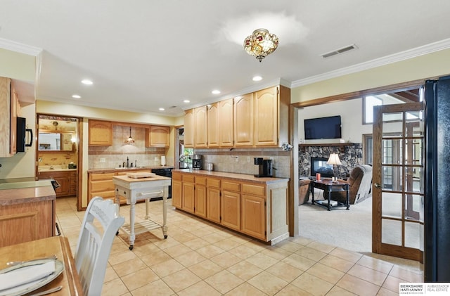 2618 Platte River Dr, Bellevue, NE 68123 - kitchen featuring crown molding, light tile patterned floors, black appliances, tasteful backsplash, and recessed lighting
