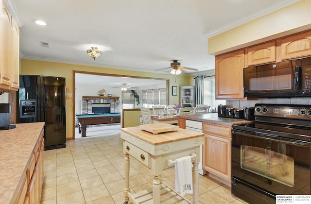 2618 Platte River Dr, Bellevue, NE 68123 - kitchen featuring black appliances, ceiling fan, ornamental molding, light tile patterned flooring, and a brick fireplace