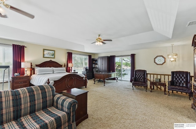 2618 Platte River Dr, Bellevue, NE 68123 - carpeted bedroom with a tray ceiling, access to exterior, a chandelier, and a ceiling fan