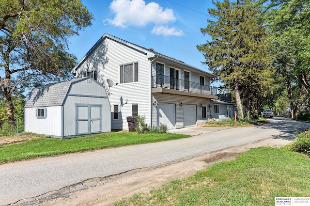 2618 Platte River Dr, Bellevue, NE 68123 - view of front of property featuring a storage unit, concrete driveway, a garage, and a front yard