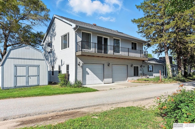 2618 Platte River Dr, Bellevue, NE 68123 - view of front facade featuring a balcony, a shed, a garage, and concrete driveway