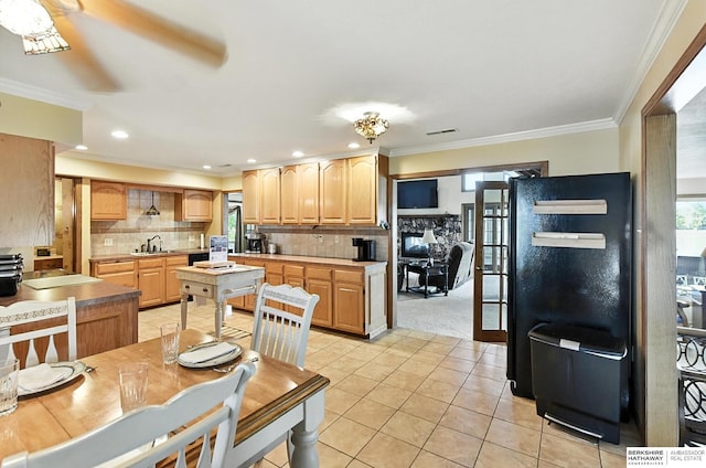 2618 Platte River Dr, Bellevue, NE 68123 - kitchen with light brown cabinets, light tile patterned floors, ornamental molding, decorative backsplash, and recessed lighting