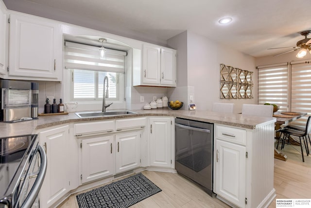 534 Piedmont Dr, Omaha, NE 68154 - kitchen featuring appliances with stainless steel finishes, a peninsula, ceiling fan, tasteful backsplash, and recessed lighting