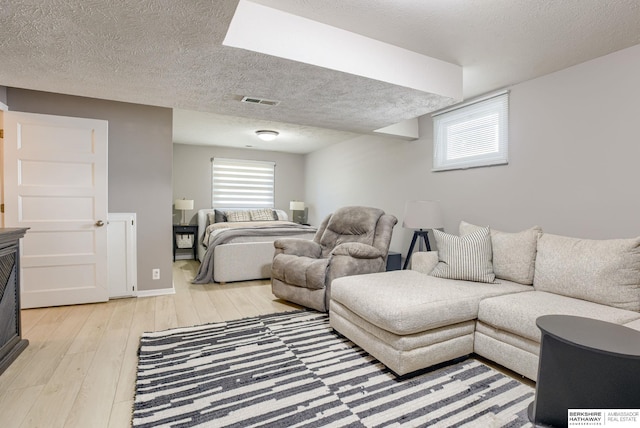534 Piedmont Dr, Omaha, NE 68154 - bedroom featuring light wood finished floors, multiple windows, and a textured ceiling