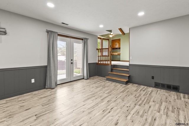3728 Schuemann Dr, Bellevue, NE 68123 - unfurnished living room with french doors, a wainscoted wall, light wood finished floors, recessed lighting, and a ceiling fan
