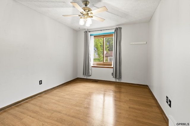 3728 Schuemann Dr, Bellevue, NE 68123 - spare room featuring light wood-style flooring, a textured ceiling, and a ceiling fan