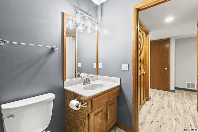 3728 Schuemann Dr, Bellevue, NE 68123 - half bath featuring vanity and wood finished floors