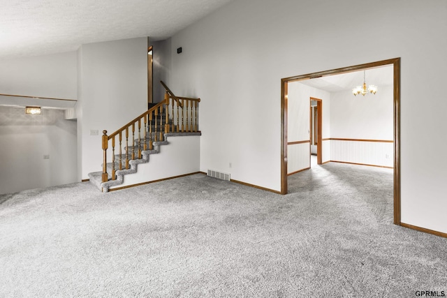 3728 Schuemann Dr, Bellevue, NE 68123 - unfurnished living room with carpet flooring, stairs, and a chandelier