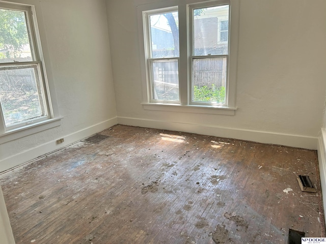 2932 N 50th St, Lincoln, NE 68504 - spare room featuring healthy amount of natural light and hardwood / wood-style floors