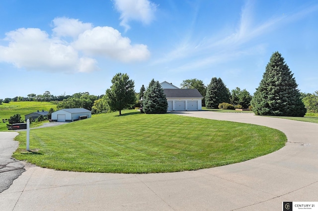 4806 Steavenson Loop, Blair, NE 68008 - view of front of house with a detached garage, a front yard, and an outbuilding