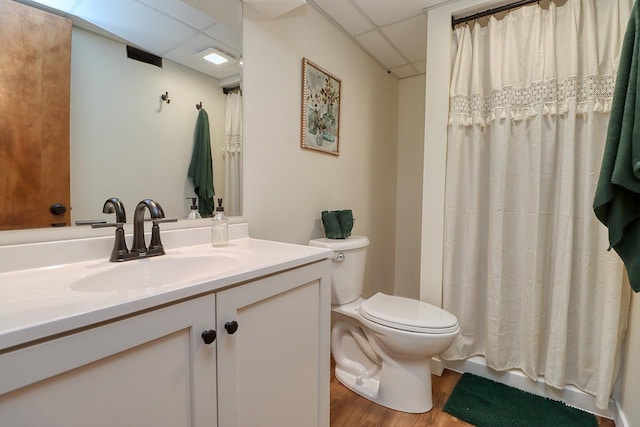 506 Rockhurst Dr, Lincoln, NE 68510 - bathroom with vanity, wood finished floors, a shower with curtain, and a paneled ceiling