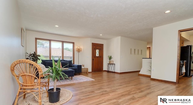506 Rockhurst Dr, Lincoln, NE 68510 - living room featuring light wood-style flooring, a textured ceiling, and recessed lighting