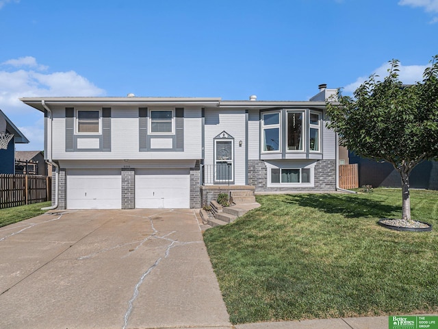 8006 S 154th St, Omaha, NE 68138 - raised ranch with an attached garage, driveway, a chimney, and stone siding