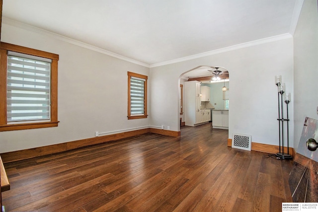 1422 S 52nd St, Omaha, NE 68106 - empty room featuring dark wood finished floors, ornamental molding, arched walkways, and a ceiling fan