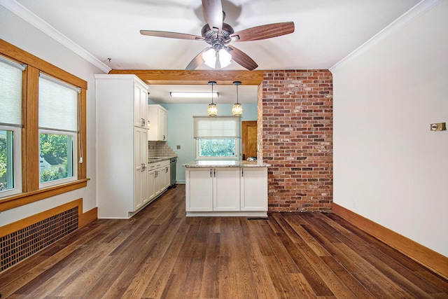 1422 S 52nd St, Omaha, NE 68106 - kitchen with radiator, white cabinets, ceiling fan, dark wood finished floors, and a peninsula
