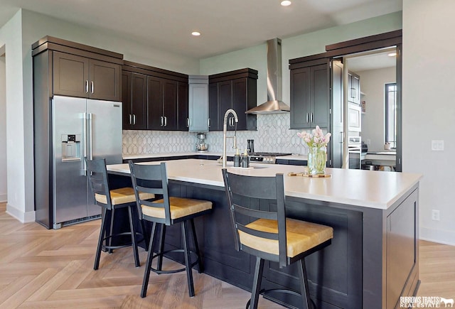 8150 S 185th St, Omaha, NE 68136 - kitchen featuring wall chimney range hood, stainless steel appliances, light countertops, tasteful backsplash, and recessed lighting