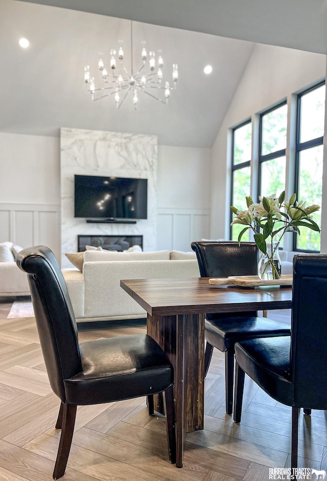 8150 S 185th St, Omaha, NE 68136 - dining space with wainscoting, a chandelier, a decorative wall, vaulted ceiling, and recessed lighting