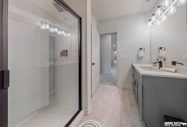 8150 S 185th St, Omaha, NE 68136 - full bathroom featuring vanity, a shower stall, and wood finished floors