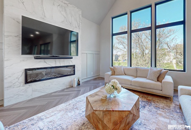 8150 S 185th St, Omaha, NE 68136 - living room with a premium fireplace, lofted ceiling, plenty of natural light, and a wainscoted wall