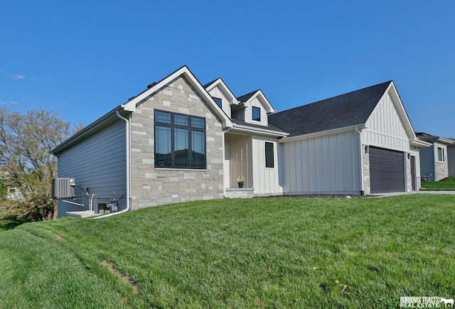 8150 S 185th St, Omaha, NE 68136 - view of front of house featuring board and batten siding, a garage, stone siding, and a front yard