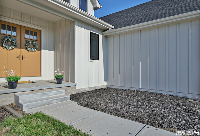 8150 S 185th St, Omaha, NE 68136 - view of exterior entry featuring board and batten siding and a shingled roof