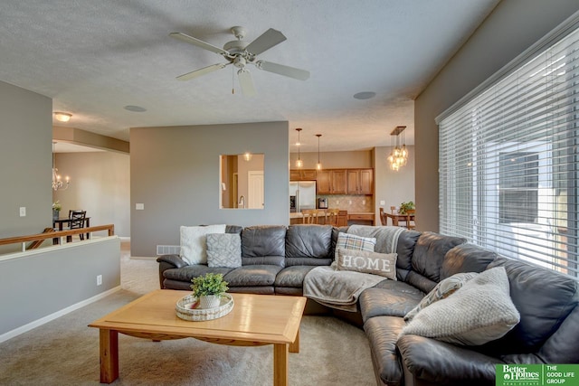 1608 Old Gaelic St, Bellevue, NE 68123 - living area with a chandelier, light carpet, and ceiling fan