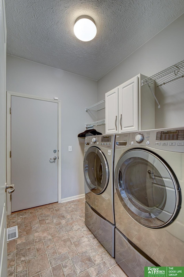 1608 Old Gaelic St, Bellevue, NE 68123 - laundry room with cabinet space, washing machine and dryer, and a textured ceiling