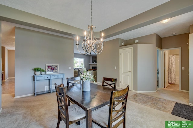 1608 Old Gaelic St, Bellevue, NE 68123 - dining space featuring light carpet, a chandelier, and a fireplace