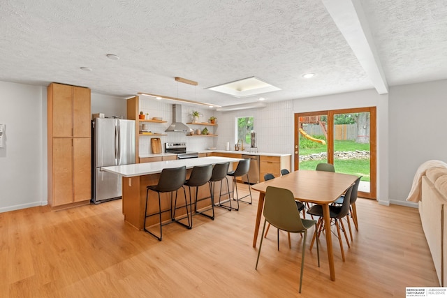 1133 S 96th St, Omaha, NE 68124 - dining area with a textured ceiling, light wood-type flooring, recessed lighting, and a skylight