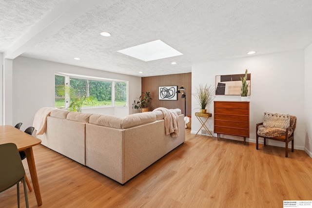 1133 S 96th St, Omaha, NE 68124 - living room featuring a skylight, light wood finished floors, recessed lighting, and a textured ceiling