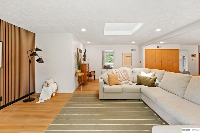 1133 S 96th St, Omaha, NE 68124 - living area featuring wood finished floors, a skylight, recessed lighting, and a textured ceiling