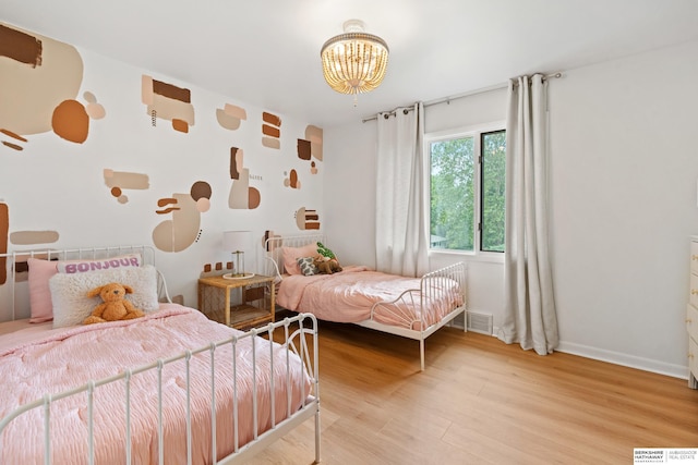 1133 S 96th St, Omaha, NE 68124 - bedroom featuring wood finished floors and a chandelier