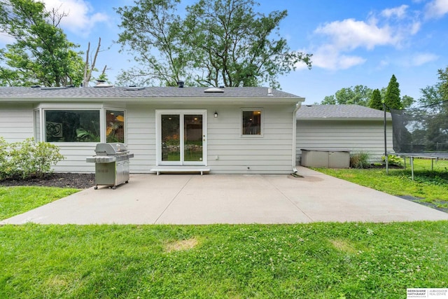 1133 S 96th St, Omaha, NE 68124 - back of property featuring a trampoline, a patio, and a lawn