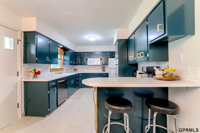 4509 Ridgeway Rd, Omaha, NE 68134 - kitchen featuring white appliances, a peninsula, decorative backsplash, and light countertops