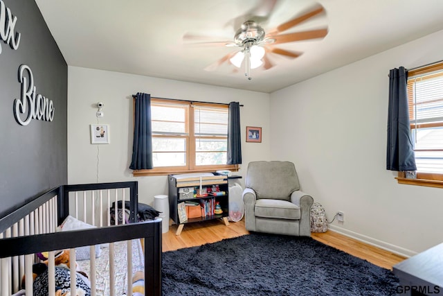4509 Ridgeway Rd, Omaha, NE 68134 - bedroom with wood finished floors and ceiling fan