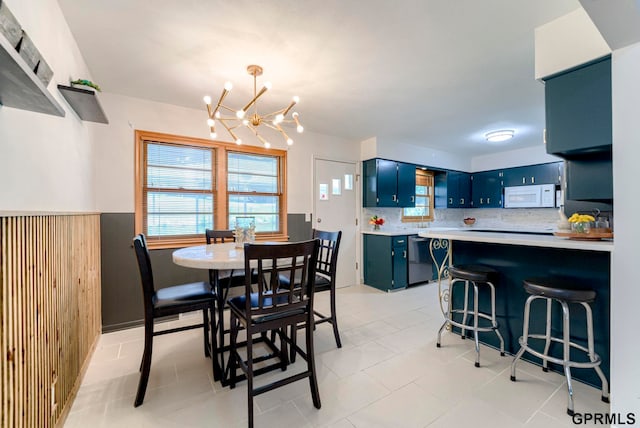 4509 Ridgeway Rd, Omaha, NE 68134 - dining room featuring a chandelier and light tile patterned flooring