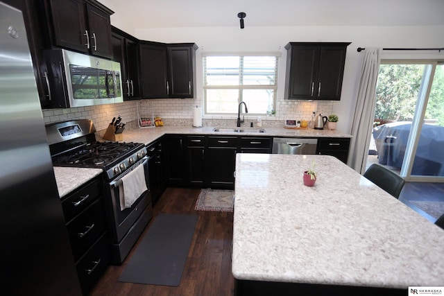 13719 S 43rd Ave, Bellevue, NE 68123 - kitchen featuring stainless steel appliances, healthy amount of natural light, dark wood finished floors, and backsplash